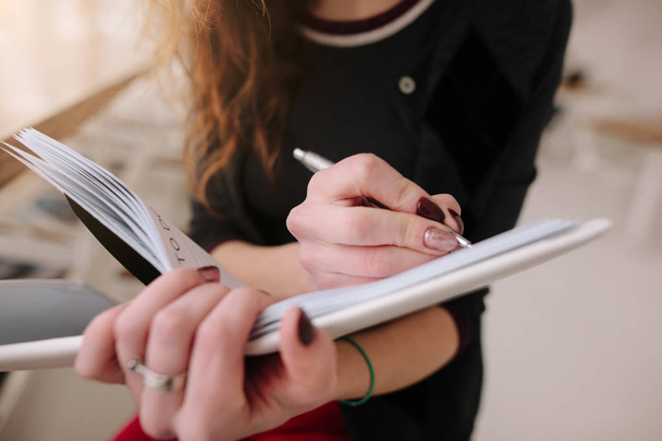 Girl writes to notebook - Фото, зображення