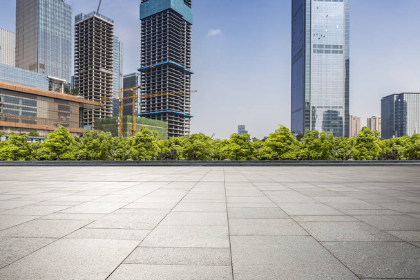 skyline panoramico e moderni edifici per uffici aziendali con strada vuota, pavimento quadrato in cemento vuoto - Foto, immagini