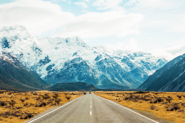 Road travel in the green mountains of New Zealand view from car window. Scenic peaks and ridges. Beautiful background of amazing nature. - Photo, image