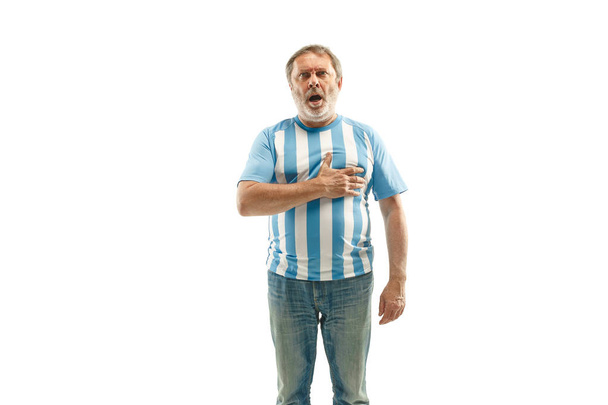 The soccer Argentinean fan celebrating on white background - Foto, afbeelding
