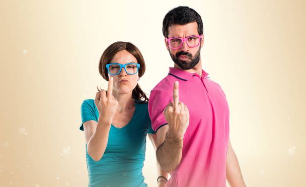 Couple in colorful clothes making crazy gesture - Photo, Image