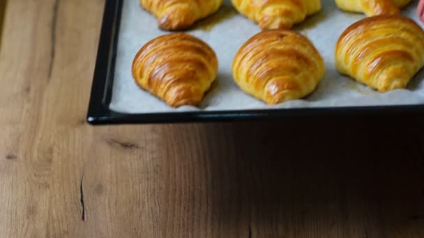 Fresh baked croissants on baking sheet - Footage, Video