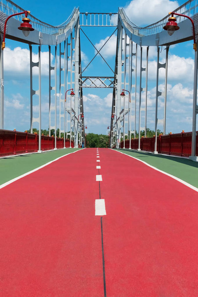 Red bike path on the bridge over the river - Photo, Image