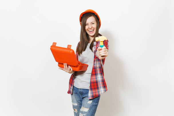 Overjoyed woman in protective hardhat holding opened case with instruments or toolbox and showing toy hammer on camera isolated on white background. Tools for renovation room. Repair home concept - Photo, Image