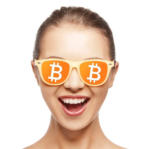 happy girl in glasses with bitcoin signs - Photo, image