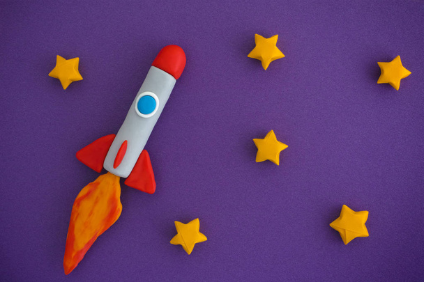 Space Rocket Flying For New Ideas Through The Stars. Space rocket is made out of play clay (plasticine). - Foto, Bild