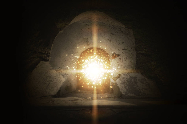 entrance to the cave, lit by a ray and magic particles - Photo, Image