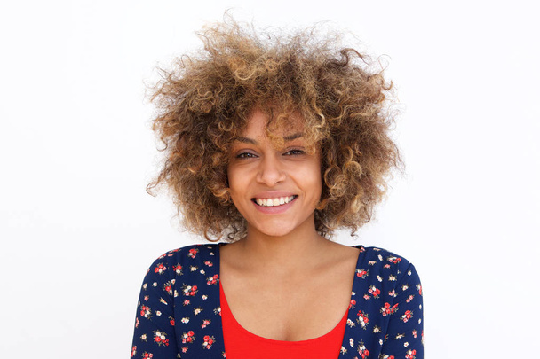 Portrait of young black woman against white background smiling - Fotografie, Obrázek