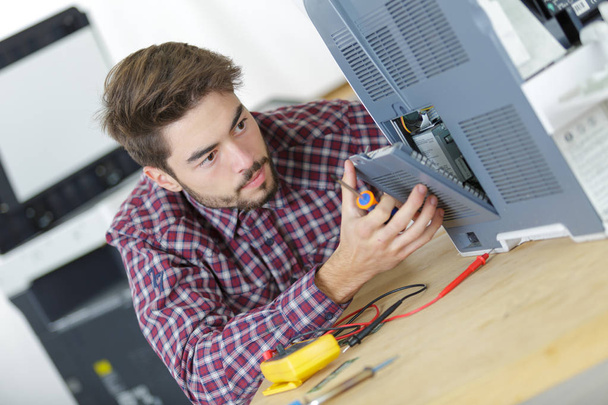 computer repairman solving problem in main-board - Фото, изображение