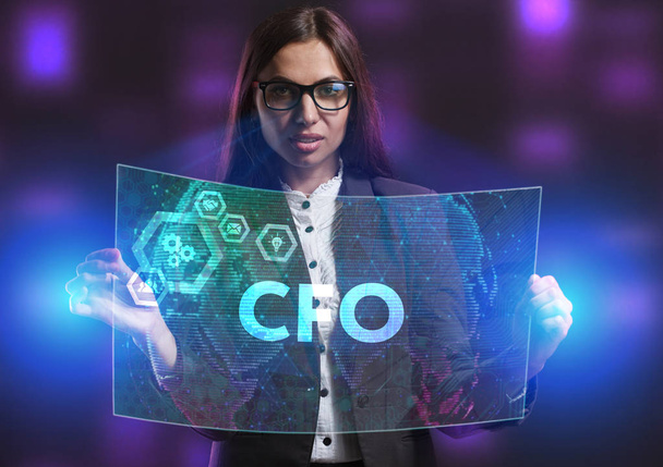 The concept of business, technology, the Internet and the network. A young entrepreneur working on a virtual screen of the future and sees the inscription: CFO - Photo, Image