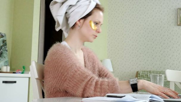 mulher de negócios atraente aplicando manchas faciais cosméticos em casa, trabalhando atrás do laptop
 - Foto, Imagem