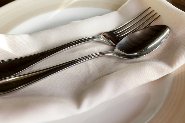 Plate with silver cutlery in a restaurant - Zdjęcie, obraz