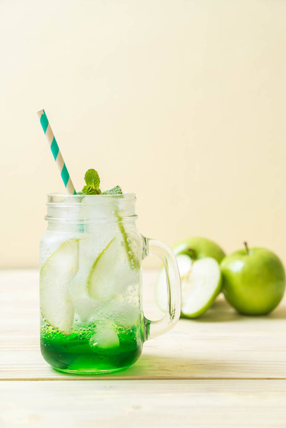 green apple soda on wood table - Фото, изображение