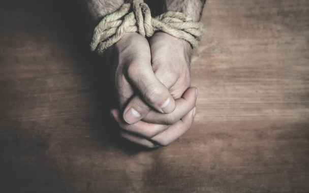 Male hands tied with a rope. - Φωτογραφία, εικόνα