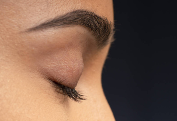 Closeup of beautiful long dark eyelashes. - Foto, imagen