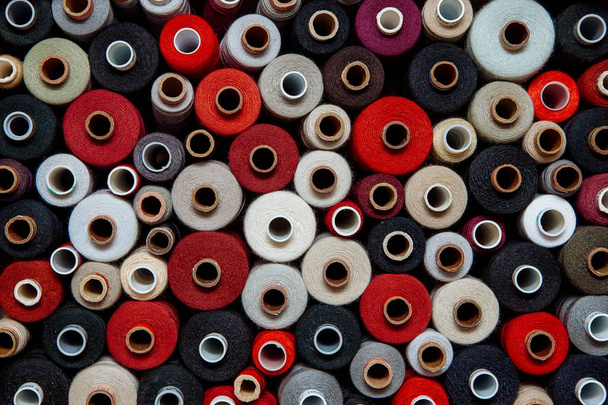 Eine Reihe von Fäden in verschiedenen Farben. Viele Näh- und Handarbeitsfäden unterscheiden sich in Farbe und Größe. Bunte Palette von Fäden. - Foto, Bild