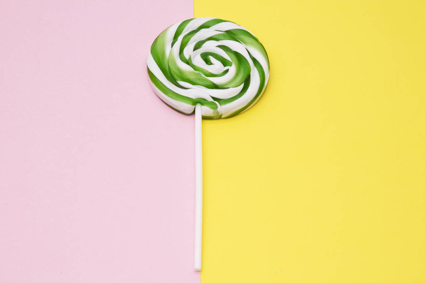 colorful lollipops on yellow and pink background - Foto, immagini