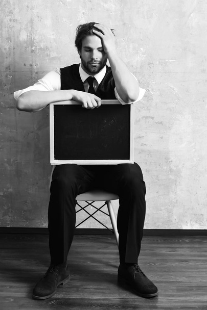 student or tired businessman holding a blackboard - Fotoğraf, Görsel