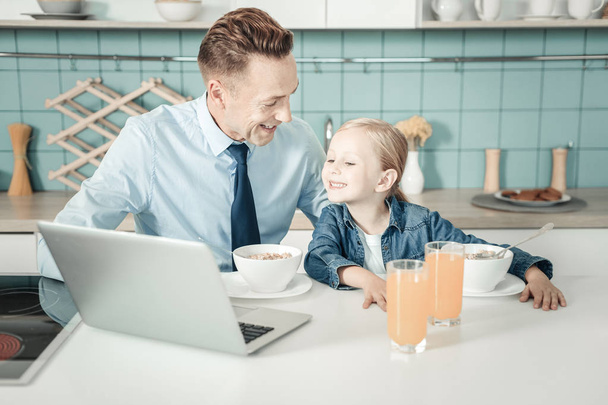 Happy little girl staring at computer - 写真・画像