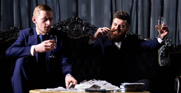Men in suit, businessmen sit in dark luxury interior background. - Foto, imagen