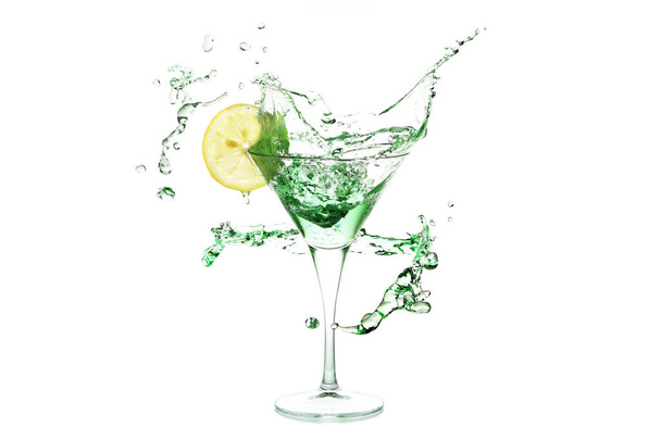 splash of martini drink with lemon slice and ice - Fotó, kép