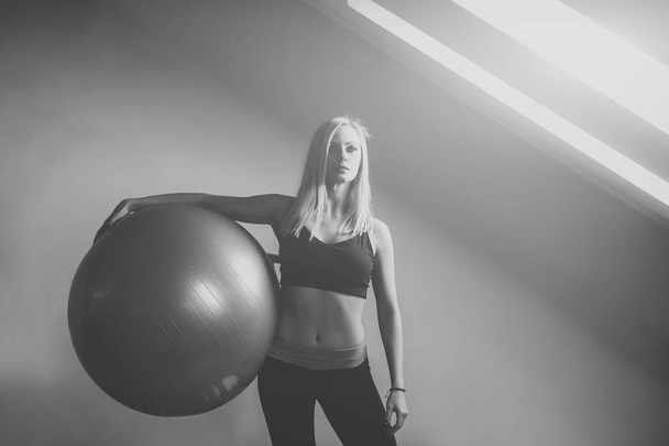 Woman with fit ball in gym - Foto, imagen