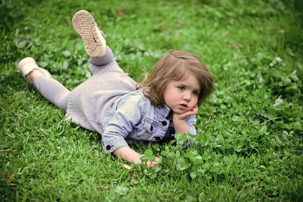 Little girl on green grass in park - Φωτογραφία, εικόνα