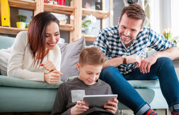 Young family using digital tablet at home - Photo, image