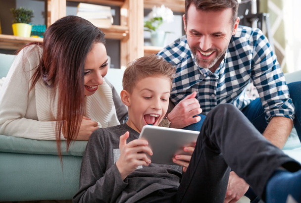 Young family using digital tablet at home - Foto, imagen