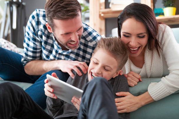 Young family using digital tablet at home - Fotografie, Obrázek