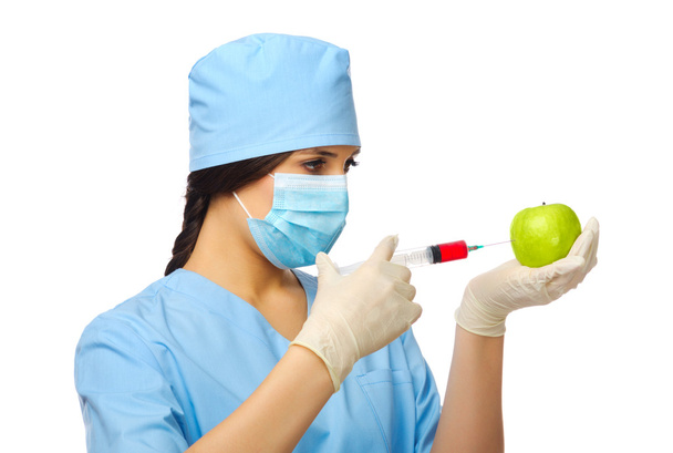 Young doctor with syringe and apple - Foto, Imagem