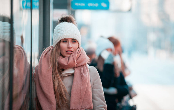 young woman walking in city street at winter time - Zdjęcie, obraz