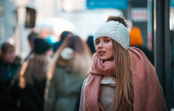 young woman walking in city street at winter time - 写真・画像