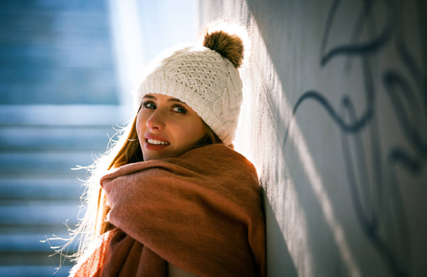 Young woman standing in underground walkway in winter day - Photo, Image