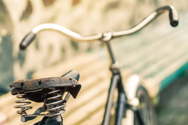 Eski bir bisiklet koltuğu bahar amortisör ile. Taş duvar arka plan üzerinde Vintage Bisiklet. - Fotoğraf, Görsel