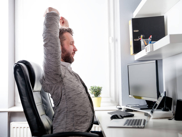 Man in desk office suffering from back pain - Фото, изображение