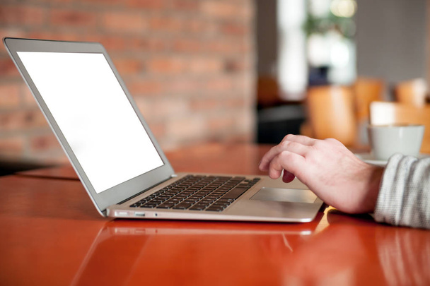 Close view of man typing on laptop keyboard in cafe - Foto, imagen