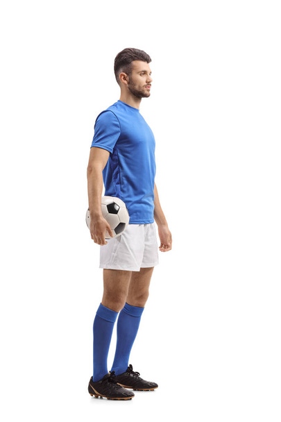 Full length profile shot of a soccer player waiting in line isolated on white background - Foto, Imagen
