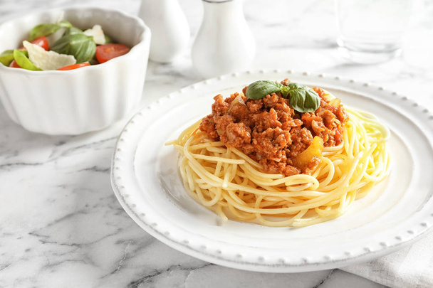 Plate with delicious pasta bolognese on table - Photo, image