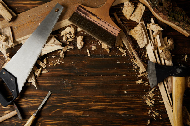elevated view of different tools and wooden pieces on tabletop - Photo, Image