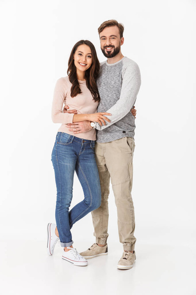 Image of cheerful young loving couple isolated over white wall background. Looking camera. - Foto, imagen