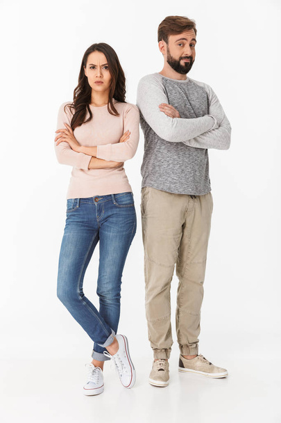 Image of displeased young loving couple isolated over white wall background quarrel. - Foto, afbeelding
