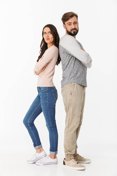 Image of displeased young loving couple isolated over white wall background quarrel. - Foto, Imagem