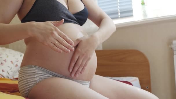 Pregnant woman stroking her stomach. - Filmati, video