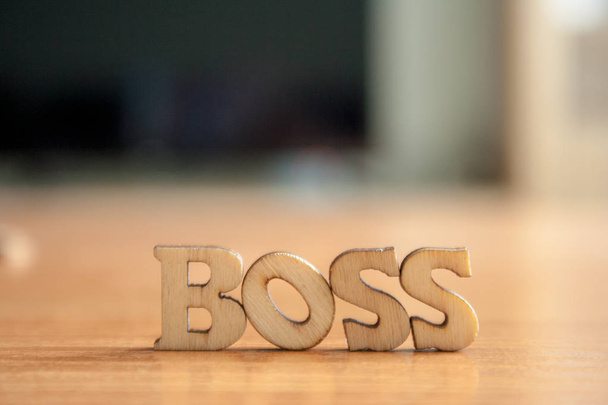 The word 'boss' made of wooden letters. wood inscription on table - Foto, afbeelding