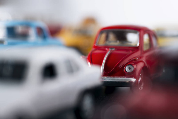 Red toy car in atraffic jam and with shallow depth of field. - Φωτογραφία, εικόνα