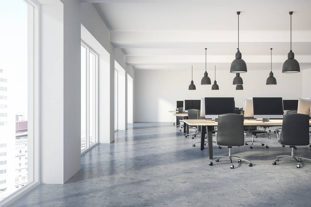 Front view of a modern company office with white walls, a concrete floor, large windows and a long wooden table with computers on them. 3d rendering mock up - Photo, image