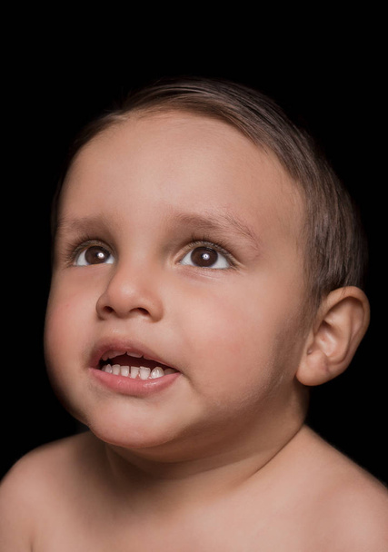 Portrait of beautiful little boy portrait on dark background - Foto, Bild