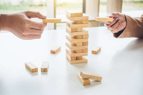 Alternative risk plan and strategy in business, Young intelligent business team playing the wood game, hands of executive cooperation placing wood block on the tower, Collaborative management. - 写真・画像