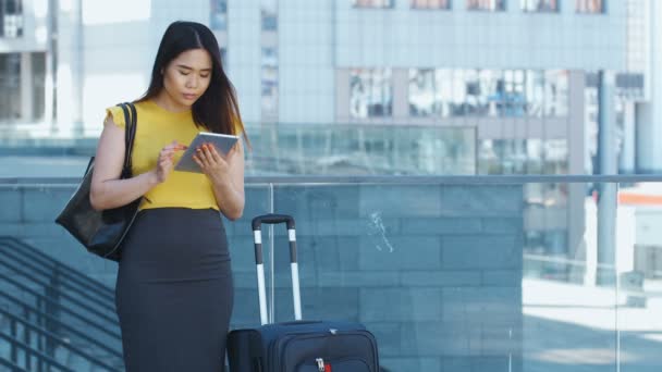 Asian female using touchpad during business travel - Footage, Video